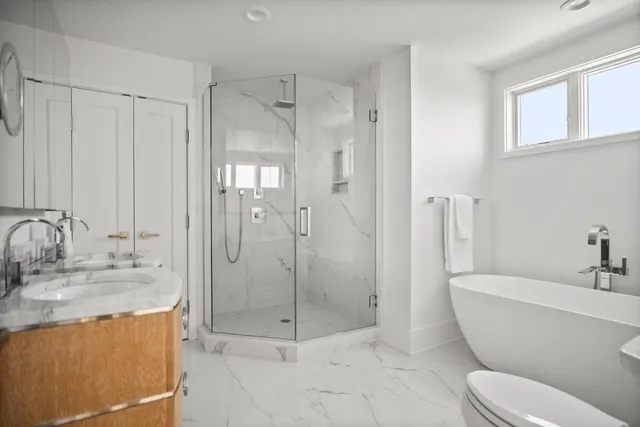 a bathroom with a granite countertop sink toilet and shower