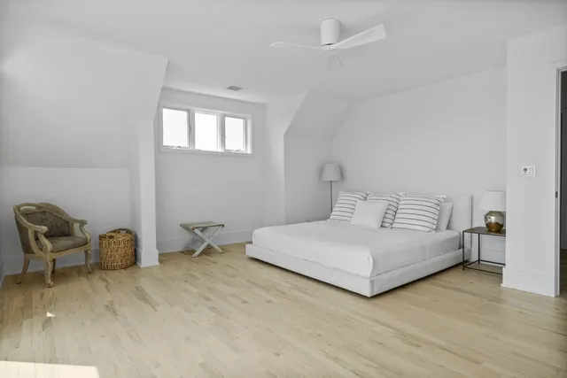 a bedroom with a bed and a chair