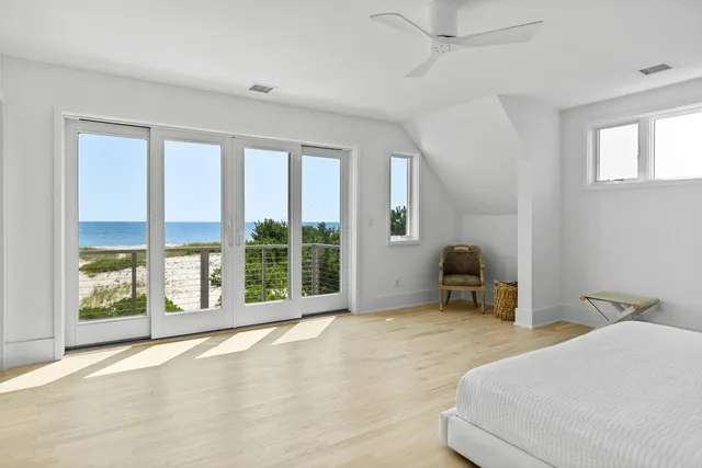 a bedroom with a bed and a large window