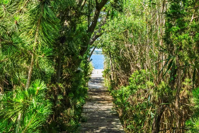a view of a balcony with wooden floor and lake view