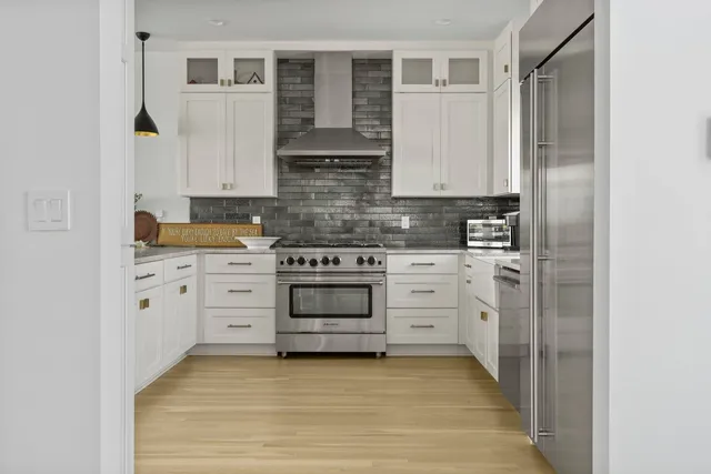 a kitchen with stainless steel appliances a stove and a refrigerator