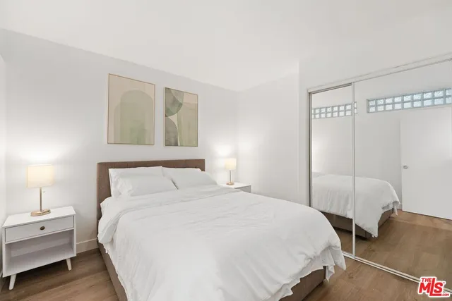 a bedroom with a bed and a night stand