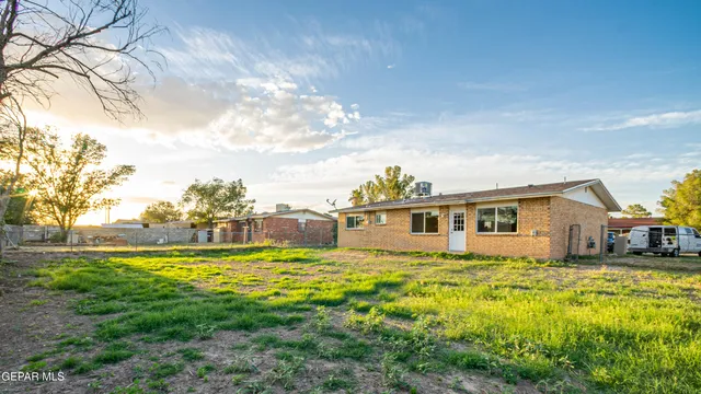 a view of a swimming pool with a yard