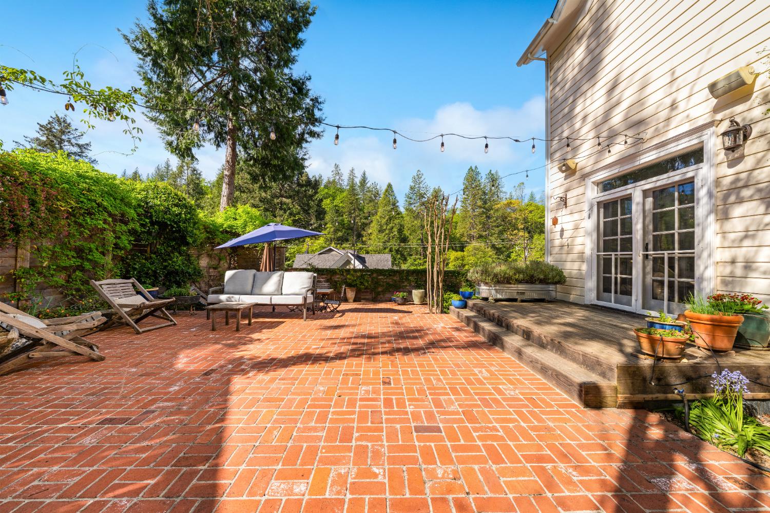 990 Thompson Way Placerville, CA 95667 - Photo 12 of 70 a view of a patio with a table and chairs under an umbrella