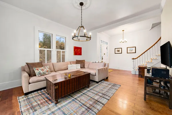 a living room with furniture flat screen tv and a window