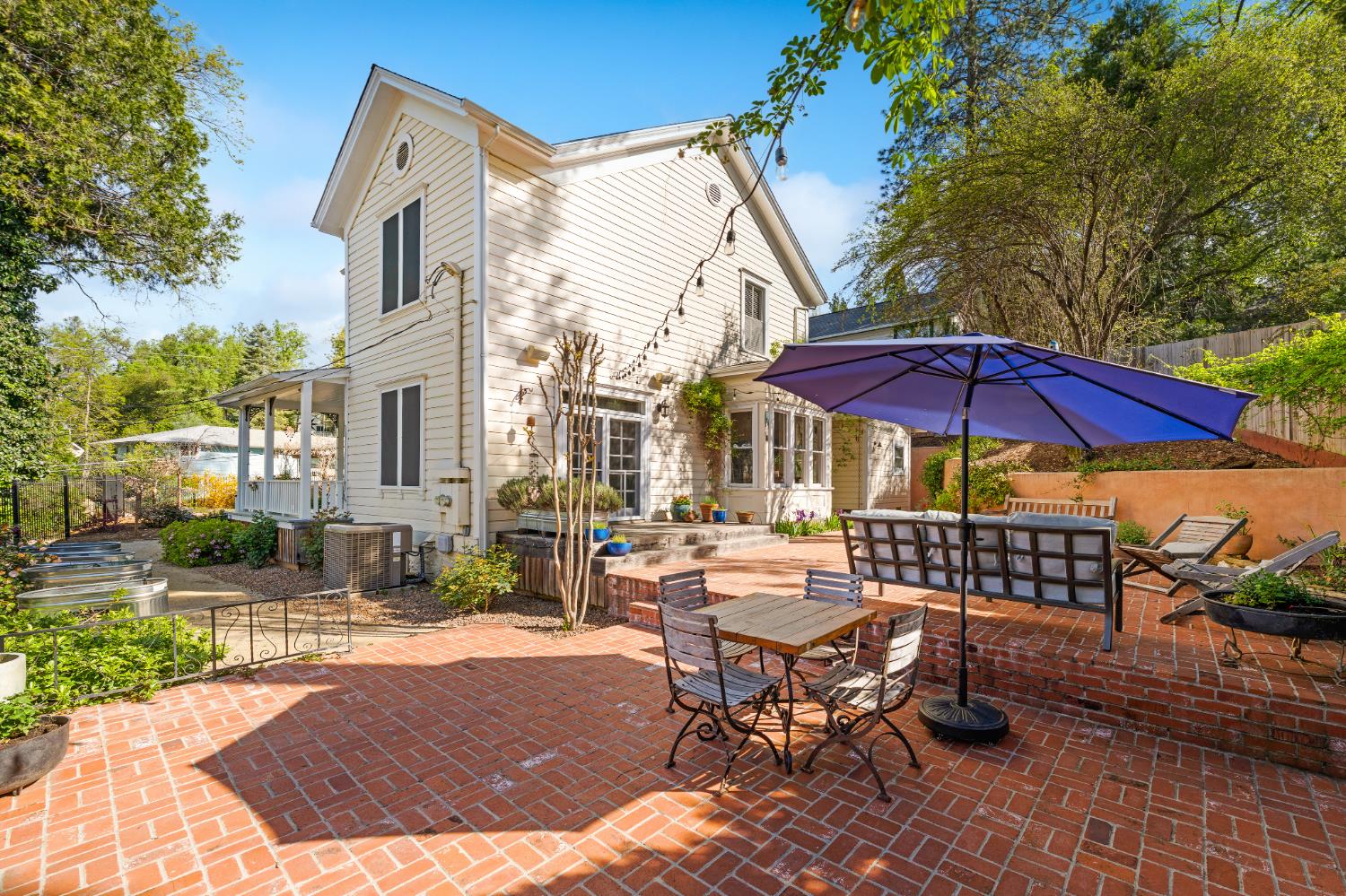 990 Thompson Way Placerville, CA 95667 - Photo 36 of 70 a view of a patio with a table and chairs under an umbrella