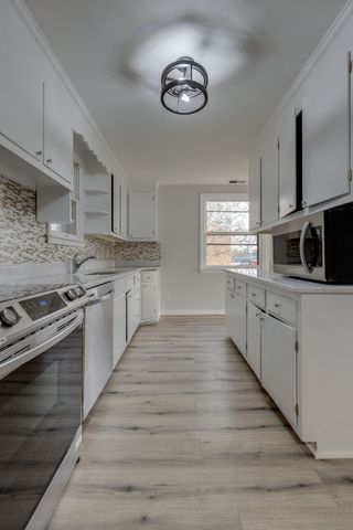 a large kitchen with a stove top oven