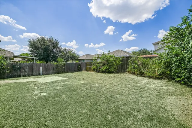 a backyard of a house with lots of green space