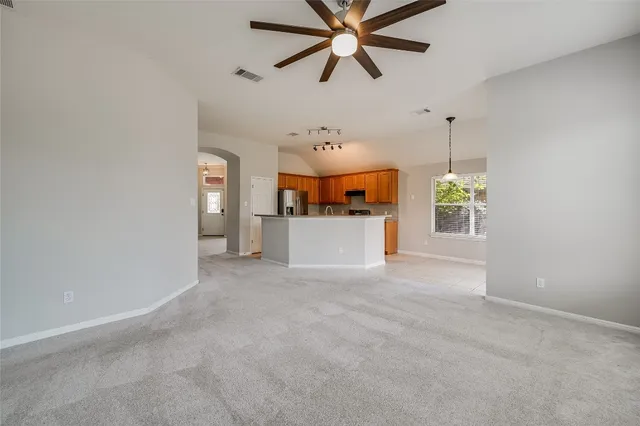 a view of a kitchen with a sink and a chandelier fan