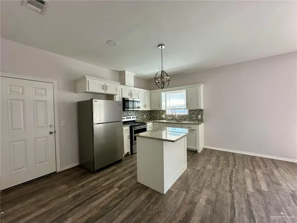 a kitchen with a sink stove and refrigerator