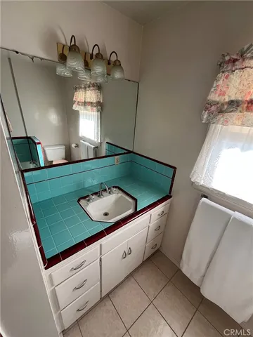 a bathroom with a sink and mirror