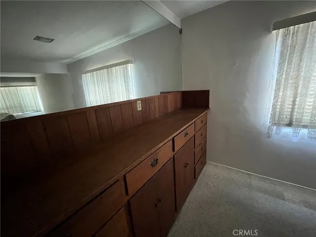 a kitchen with wooden cabinets
