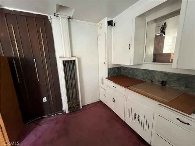 a kitchen with granite countertop a refrigerator and a sink