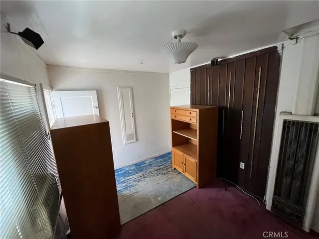 a view of kitchen with refrigerator and window