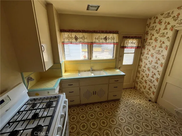 a bathroom with a granite countertop sink toilet a mirror and shower