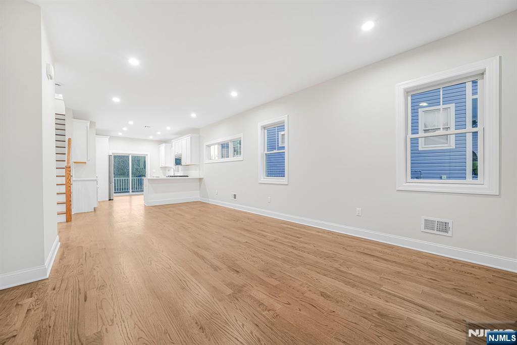 18 Birdie Lane Boonton, NJ 07005 - Photo 13 of 36 a view of an empty room with wooden floor and a window