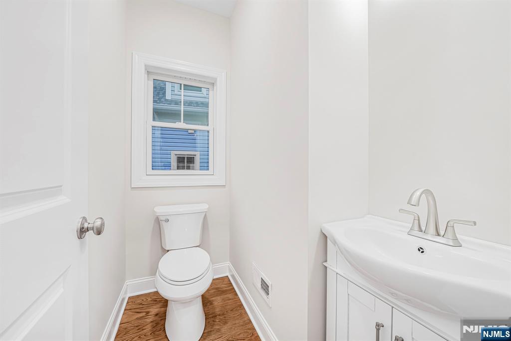 18 Birdie Lane Boonton, NJ 07005 - Photo 15 of 36 a bathroom with a toilet sink and a mirror