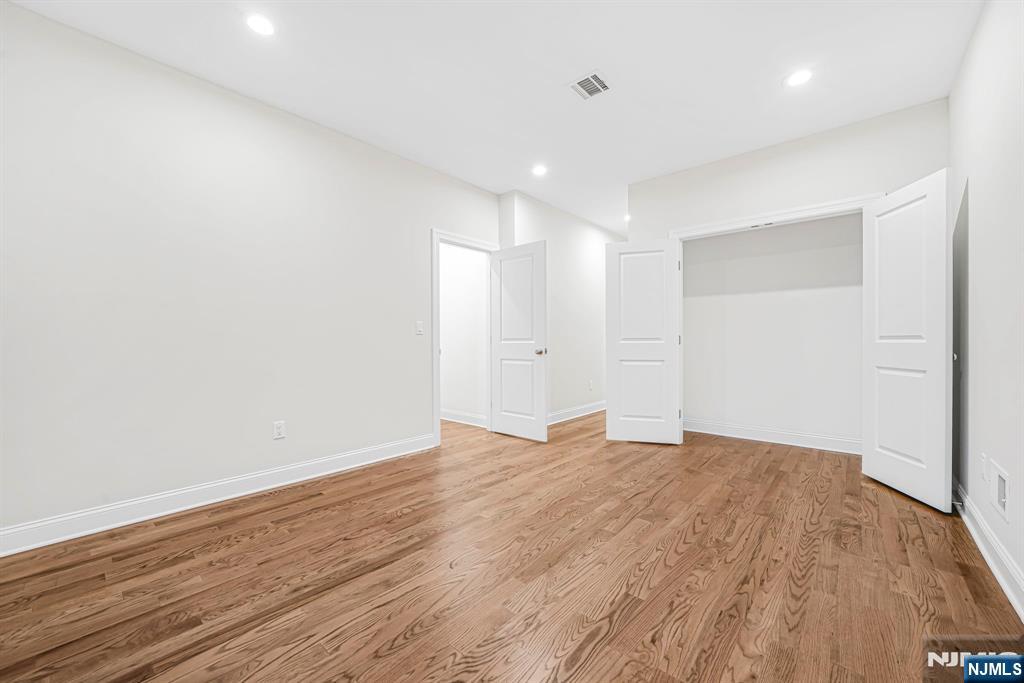 18 Birdie Lane Boonton, NJ 07005 - Photo 17 of 36 a view of an empty room with wooden floor