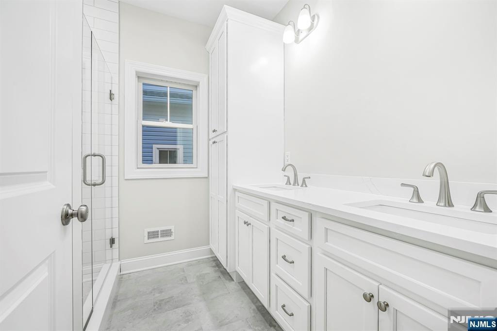 18 Birdie Lane Boonton, NJ 07005 - Photo 18 of 36 a spacious bathroom with double sink and a mirror