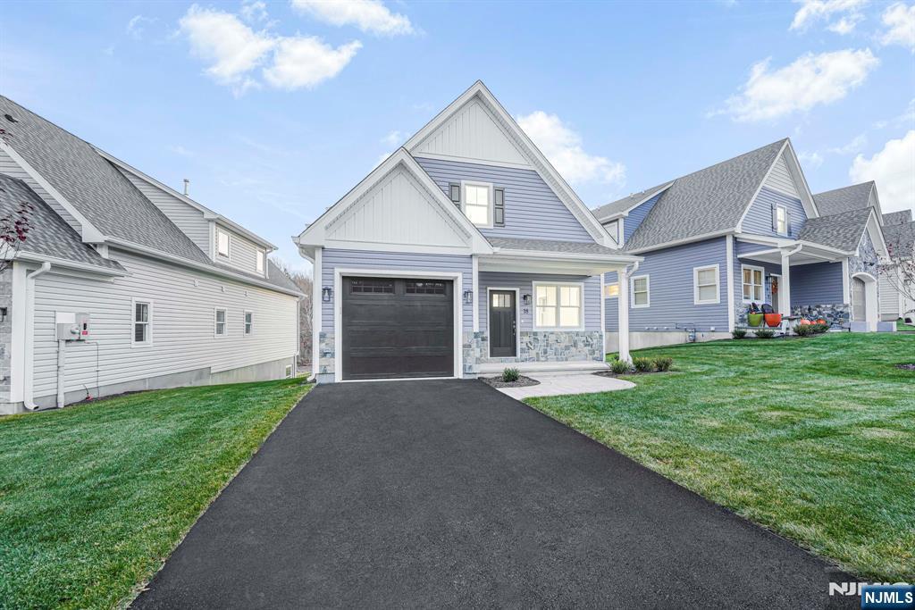 18 Birdie Lane Boonton, NJ 07005 - Photo 2 of 36 a front view of a house with a yard and garage