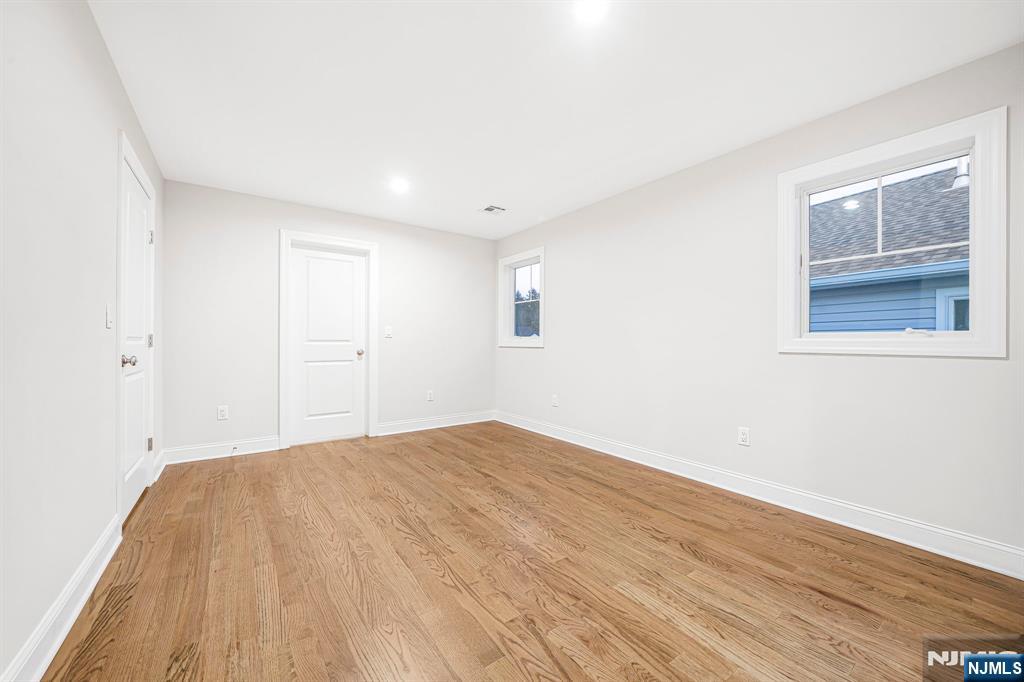 18 Birdie Lane Boonton, NJ 07005 - Photo 21 of 36 a view of empty room with wooden floor and fan