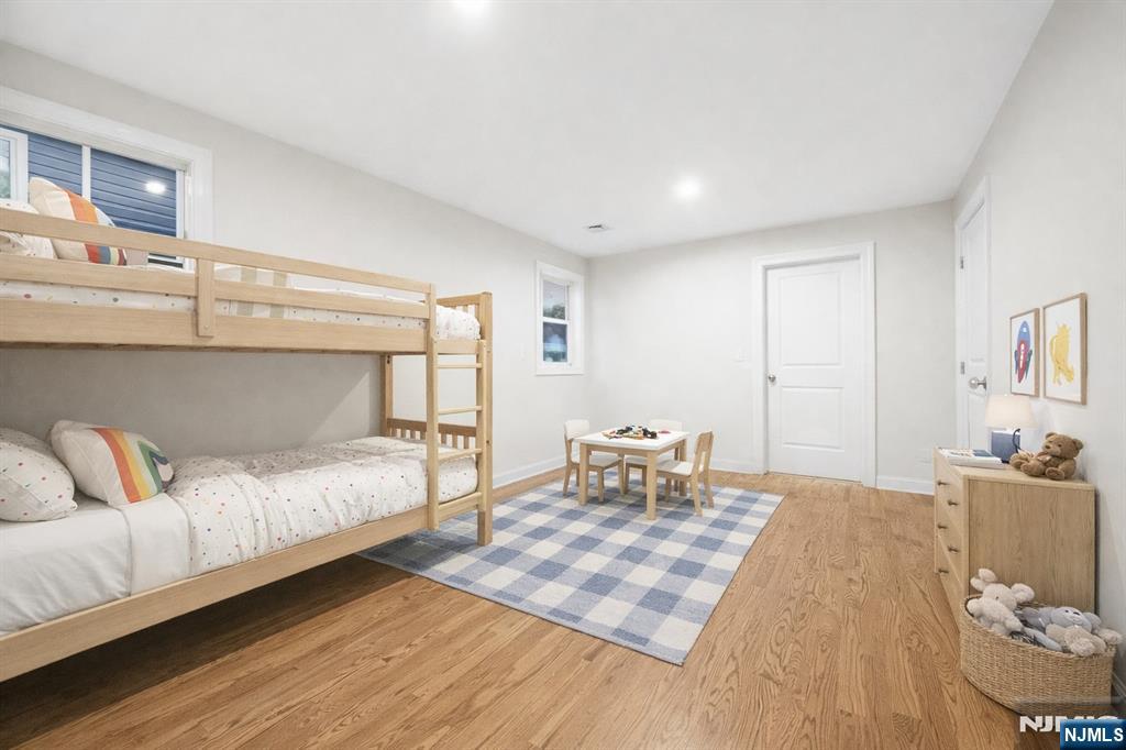 18 Birdie Lane Boonton, NJ 07005 - Photo 10 of 36 a bedroom with a bed and wooden floor