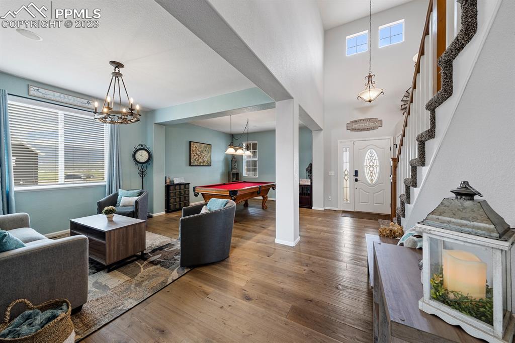 1465 Bowstring Road Monument, CO 80132 - Photo 14 of 49 a living room with furniture and a chandelier
