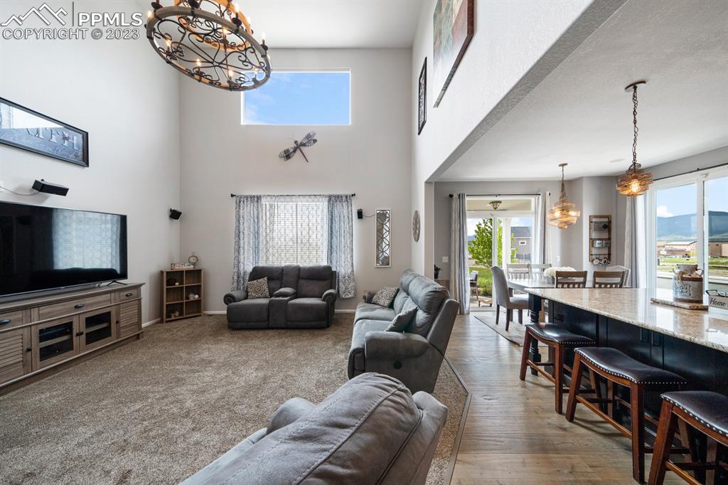 1465 Bowstring Road Monument, CO 80132 - Photo 15 of 49 a living room with furniture and a flat screen tv