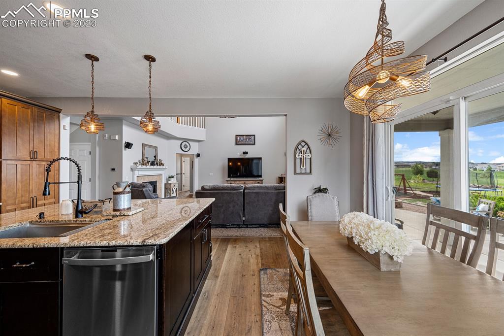 1465 Bowstring Road Monument, CO 80132 - Photo 18 of 49 a very nice looking dining room with a large window and chandelier
