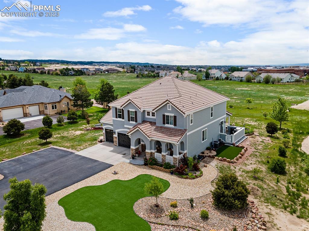 1465 Bowstring Road Monument, CO 80132 - Photo 2 of 49 an aerial view of a house with yard swimming pool and green space