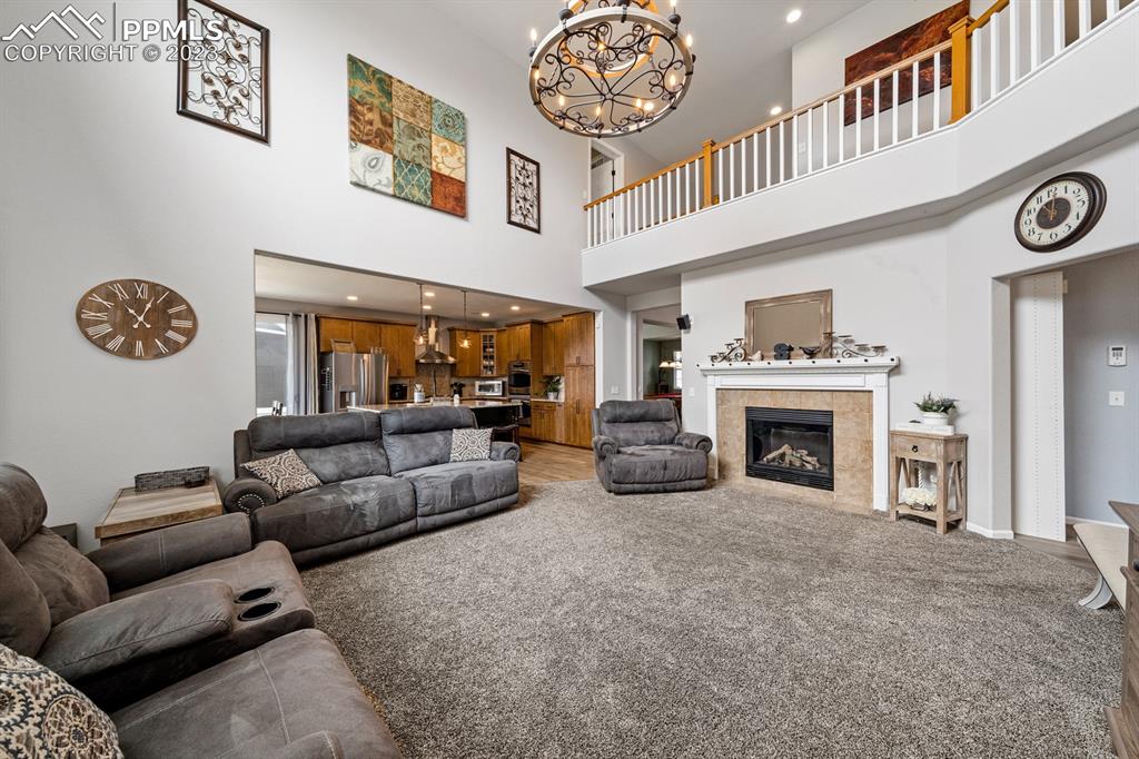 1465 Bowstring Road Monument, CO 80132 - Photo 21 of 49 a living room with furniture and a fireplace