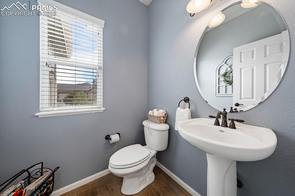 1465 Bowstring Road Monument, CO 80132 - Photo 23 of 49 a bathroom with a toilet sink and mirror