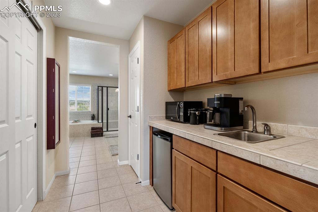 1465 Bowstring Road Monument, CO 80132 - Photo 26 of 49 a kitchen with stainless steel appliances granite countertop a refrigerator and sink