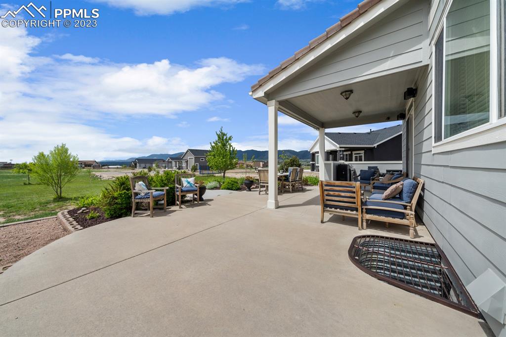1465 Bowstring Road Monument, CO 80132 - Photo 37 of 49 a view of a patio with a table and chairs and potted plants