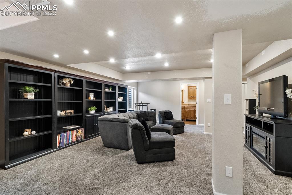 1465 Bowstring Road Monument, CO 80132 - Photo 41 of 49 a living room with furniture and a flat screen tv