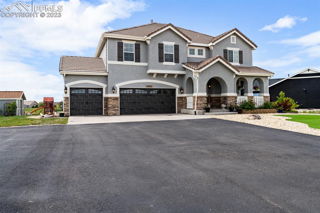 1465 Bowstring Road Monument, CO 80132 - Photo 5 of 49 a front view of a house with a yard