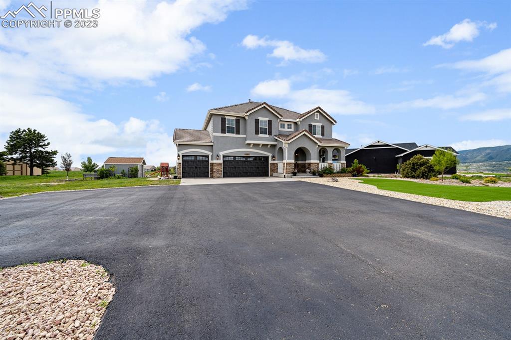 1465 Bowstring Road Monument, CO 80132 - Photo 6 of 49 a large tree in front of the house