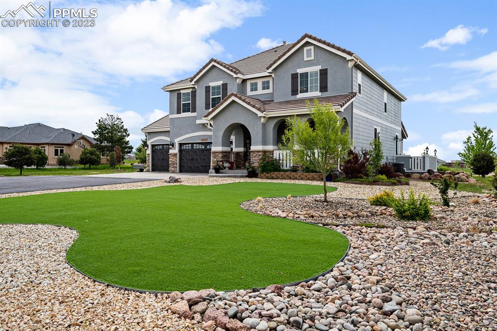 1465 Bowstring Road Monument, CO 80132 - Photo 8 of 49 a front view of a house with a yard