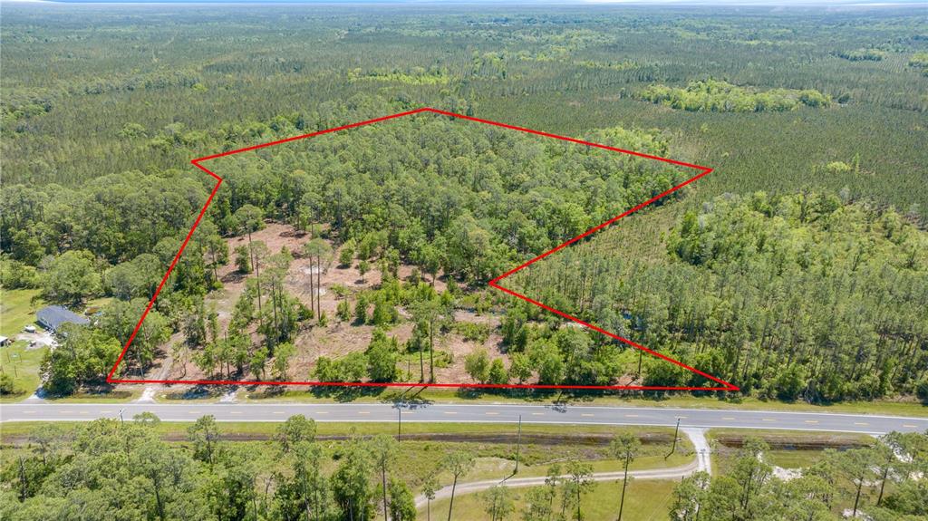 1351 Highway 24 Chiefland, FL 32626 - Photo 2 of 5 an aerial view of residential houses with outdoor space and trees