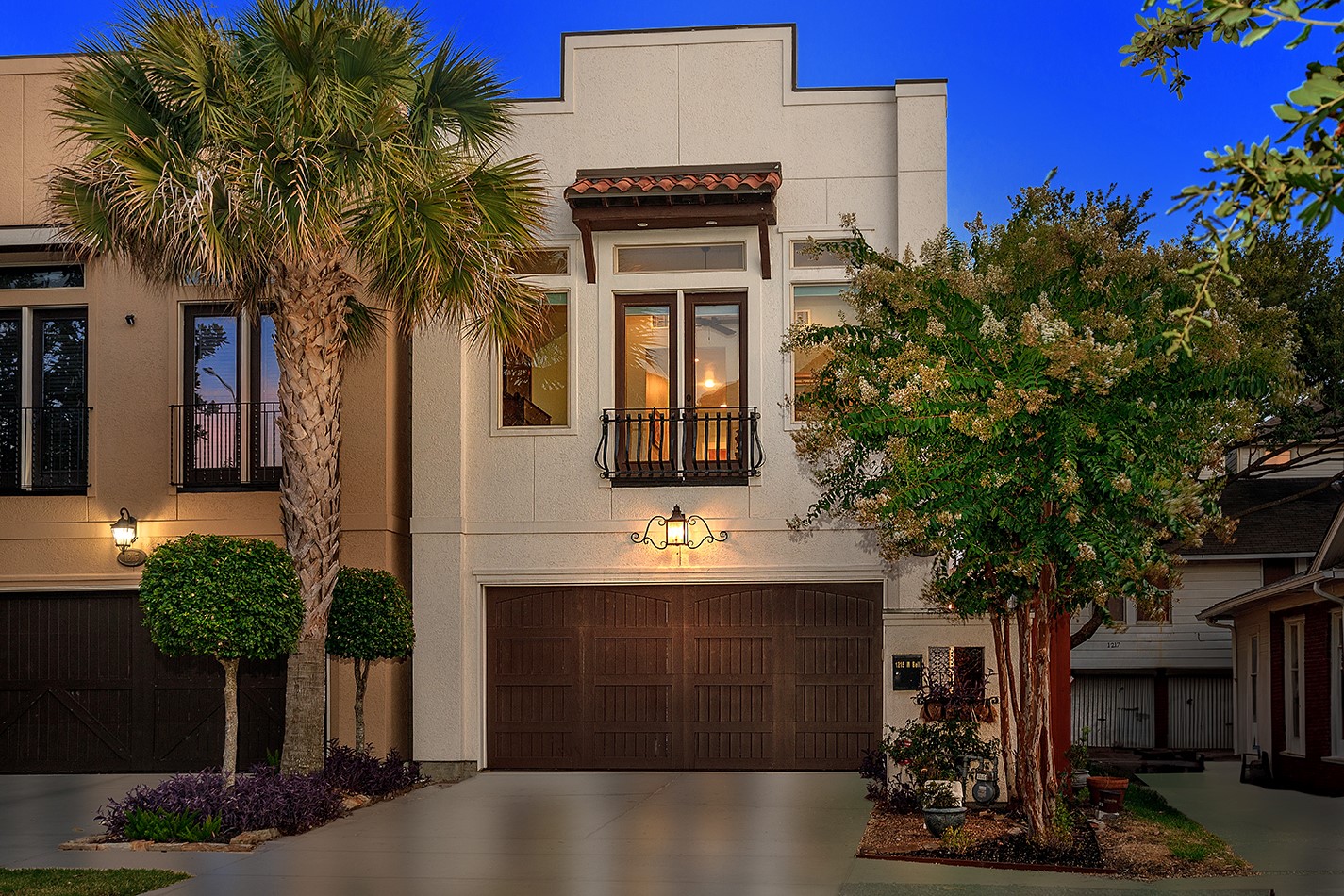 a front view of a house with a tree