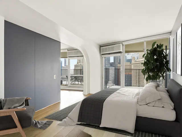 a bedroom with a large bed and a window