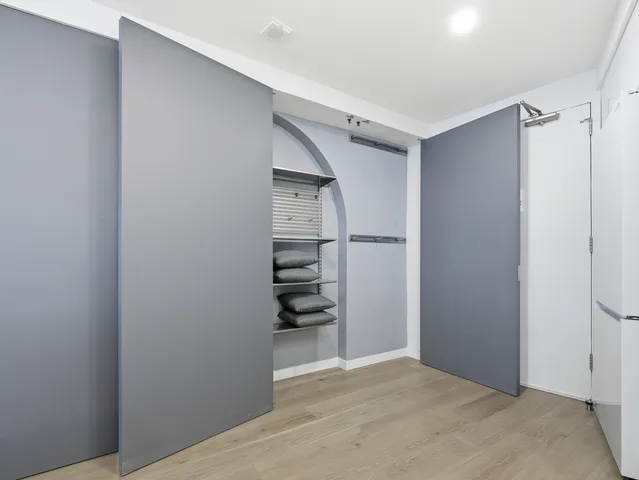 a view of walk in closet with empty racks