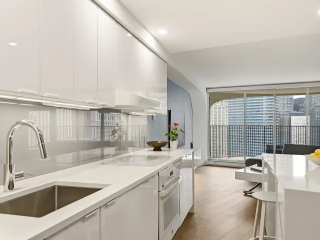 a kitchen with a sink and a large window