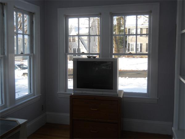 73 Perkins Street Springfield, MA 01118 - Photo 8 of 17 a view of an empty room with wooden floor and a window