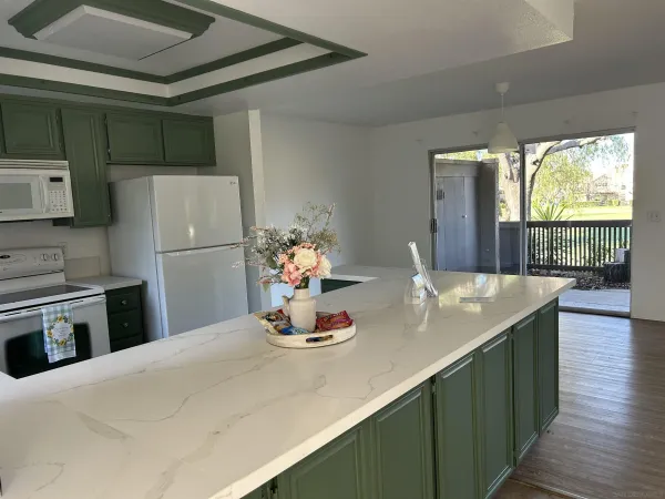 a kitchen with a refrigerator and a stove top oven