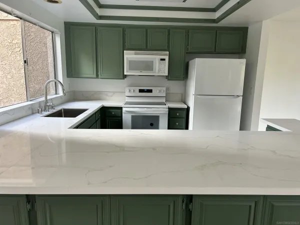 a kitchen with a refrigerator and a sink