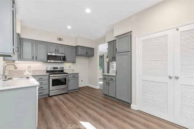 a kitchen with stainless steel appliances a refrigerator stove and sink