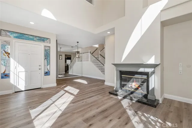 a view of a livingroom with wooden floor and a fireplace