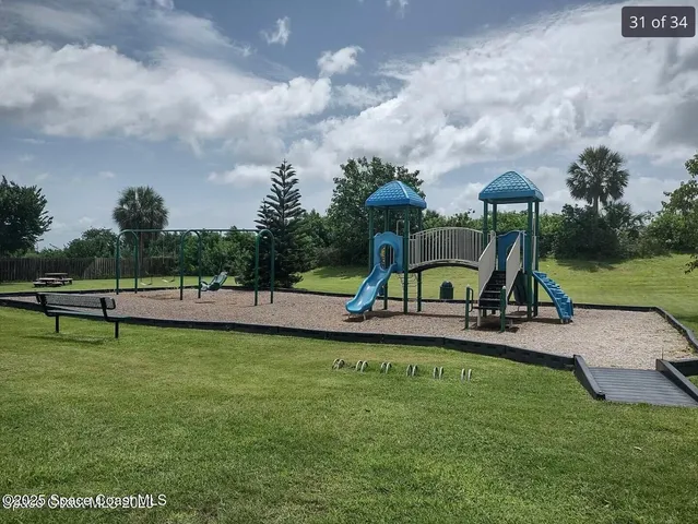a view of a garden with sitting area