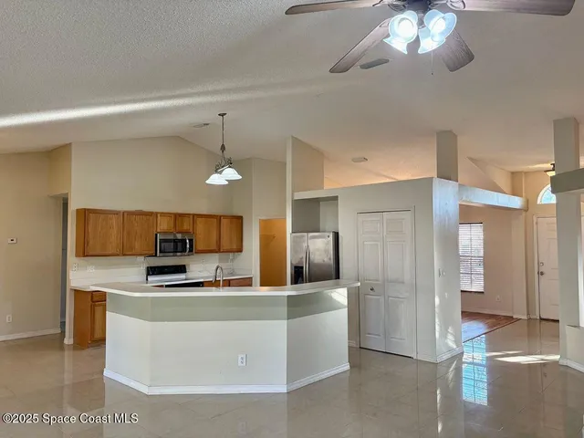 a kitchen with stainless steel appliances a refrigerator a stove top oven a sink and dishwasher